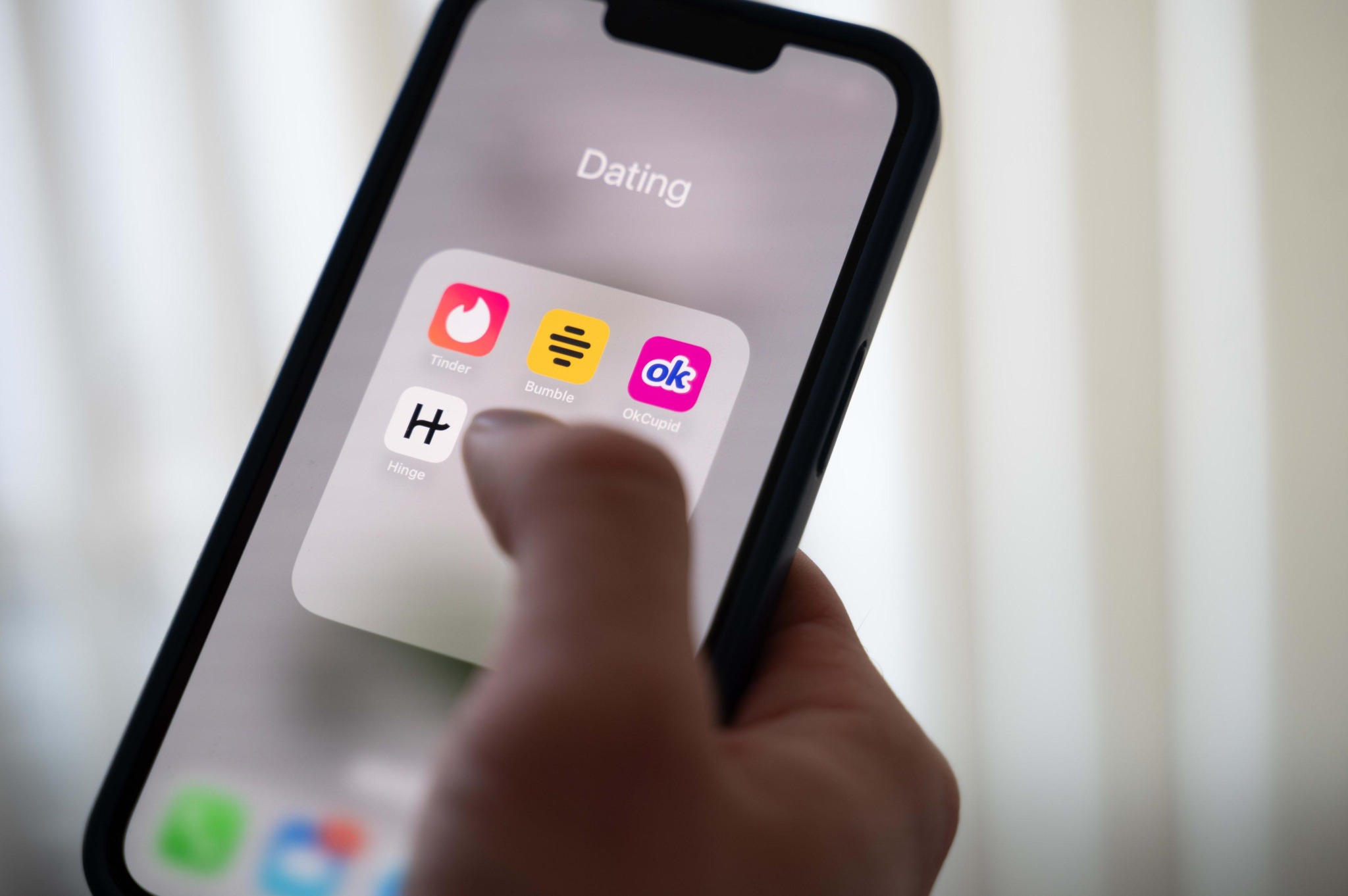 Phone showing dating app icons for MatchGauge deals