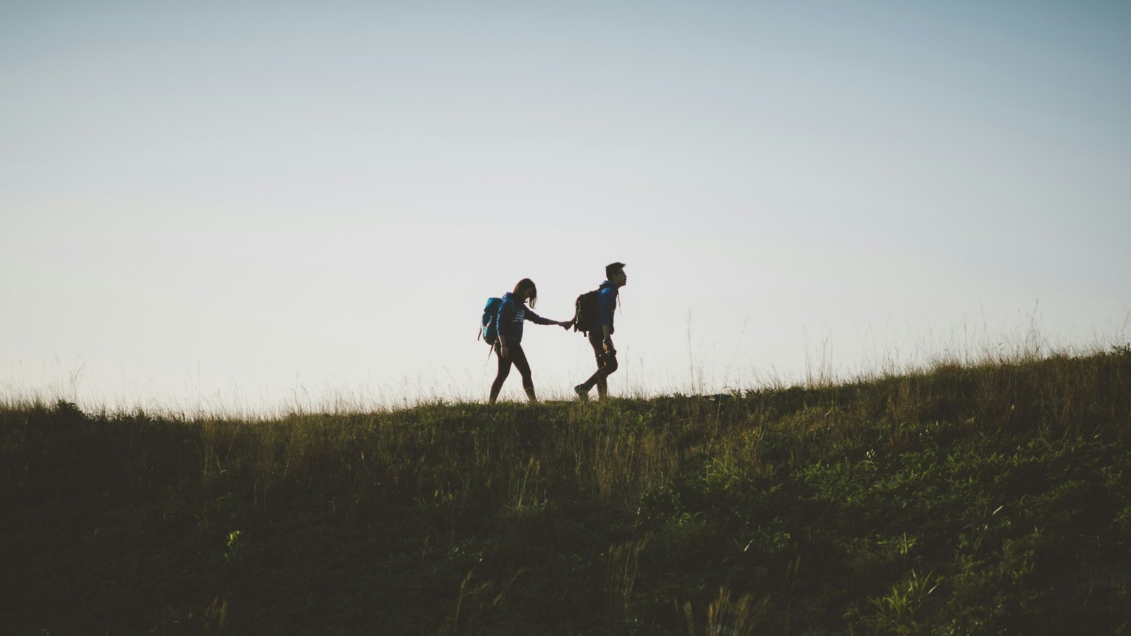 Couple walking and laughing at a relaxed pace
